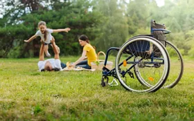 A family in a park and a wheelchair